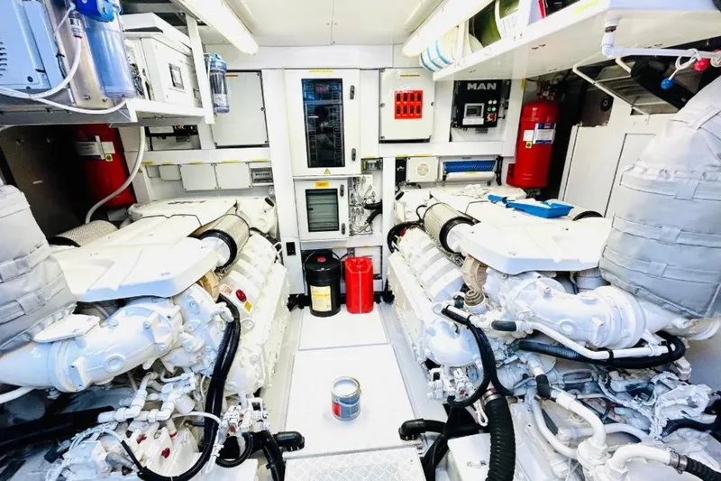 Sarahlisa Yacht Photos Pics Engine room of a 2015 Sunseeker 75 yacht, featuring dual engines and safety equipment.