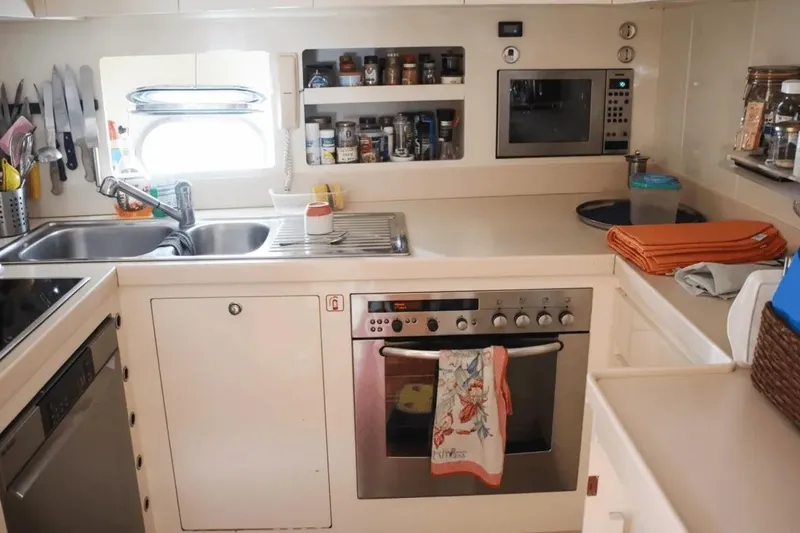  Yacht Photos Pics Compact yacht kitchen with modern appliances on a 2000 Cantieri dell'Arno Leopard 27 open.
