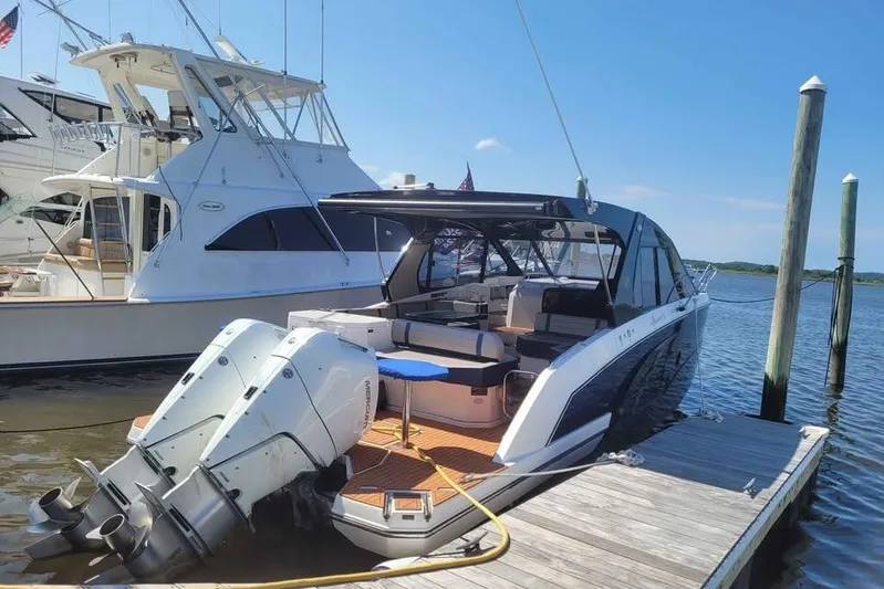  Yacht Photos Pics 2024 Hanover 387 boat docked, featuring dual outboard motors and sleek design.