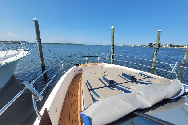  Yacht Photos Pics 2024 Hanover 387 boat docked on a sunny day, featuring a spacious deck and serene water view.
