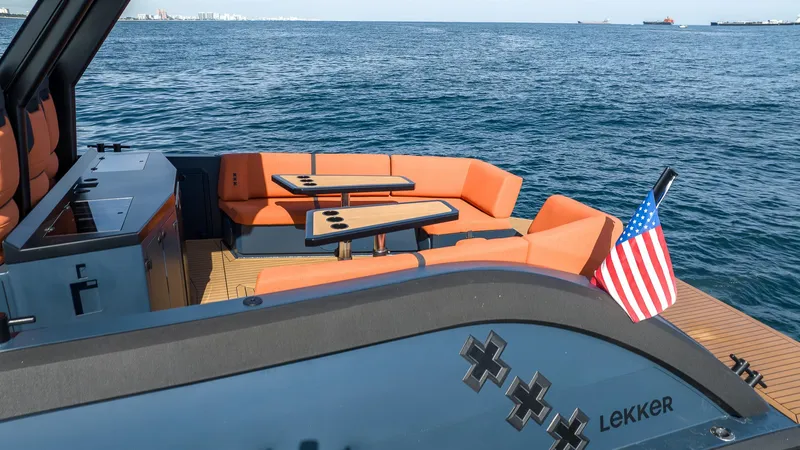  Yacht Photos Pics Lekker 44 boat, 2023 model, with orange seating and American flag on open water.
