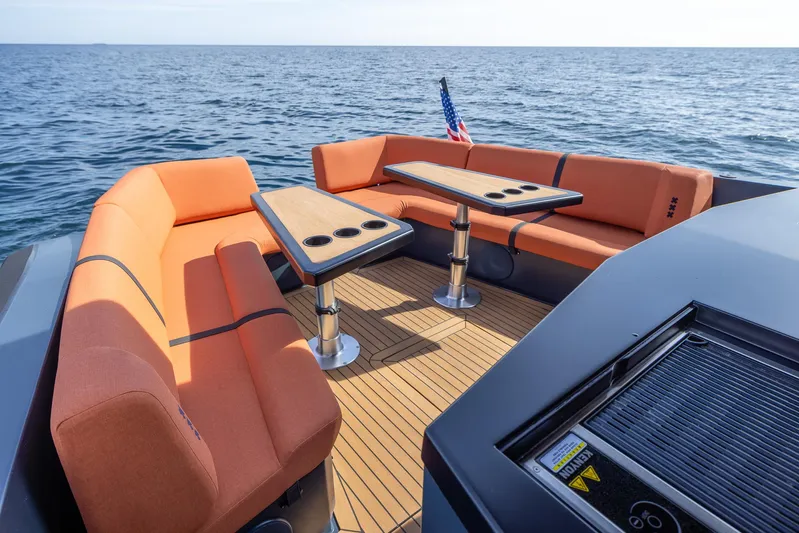  Yacht Photos Pics Lekker 44 (2023) boat with orange seating and tables on open water.