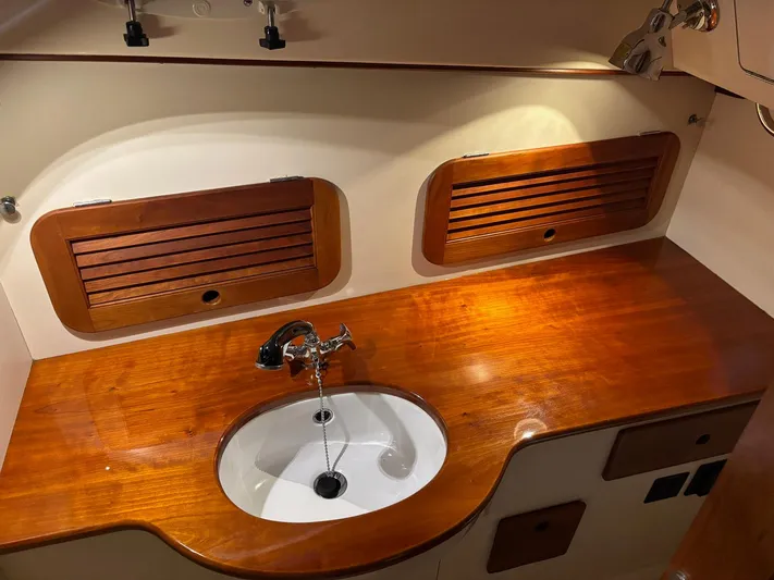 Celebration Yacht Photos Pics Hinckley Picnic Boat 36 (2002) interior with wooden countertop and sink.