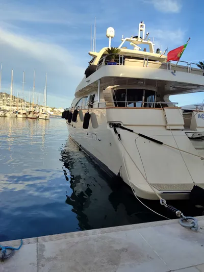  Yacht Photos Pics Luxury 1999 Azimut 100 Jumbo yacht docked in a serene marina setting.