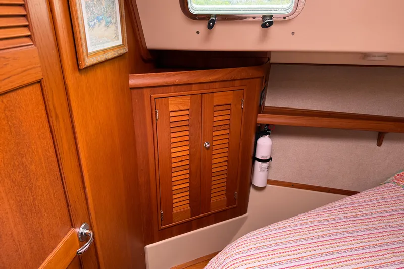 Pelican Yacht Photos Pics Interior of 2008 Island Packet 370 sailboat with wooden cabinetry and fire extinguisher.