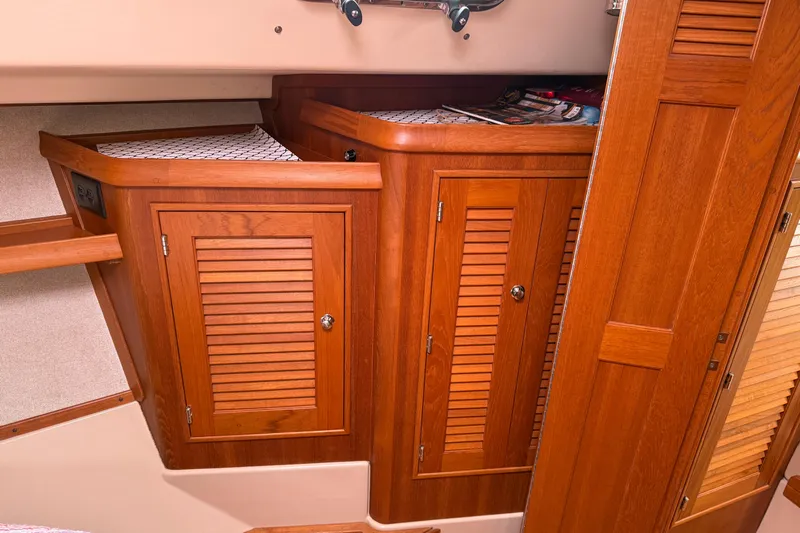 Pelican Yacht Photos Pics 2008 Island Packet 370 interior with wooden cabinets and storage space.
