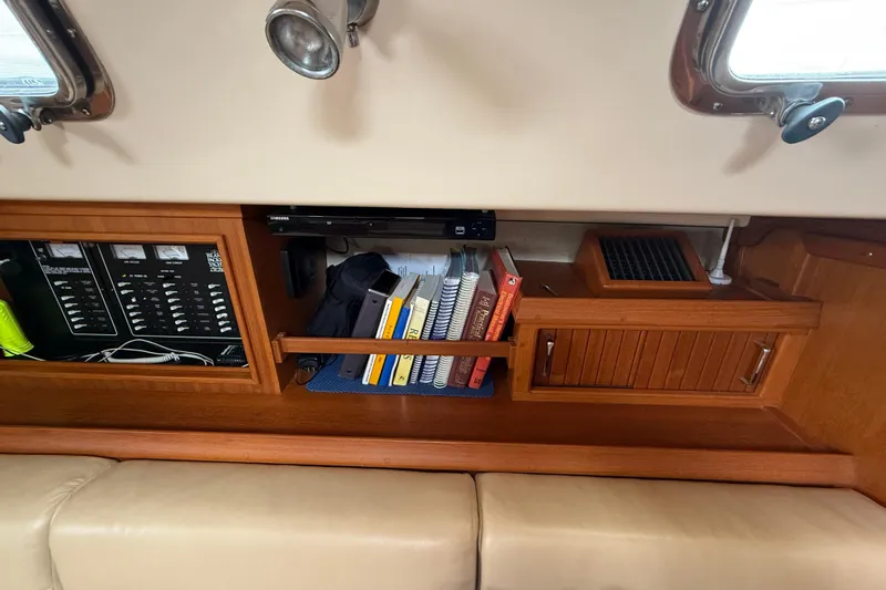 Pelican Yacht Photos Pics Interior of 2008 Island Packet 370 sailboat with books and control panel.