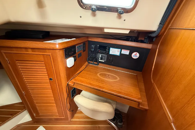 Pelican Yacht Photos Pics 2008 Island Packet 370 navigation station with wooden desk and control panel.