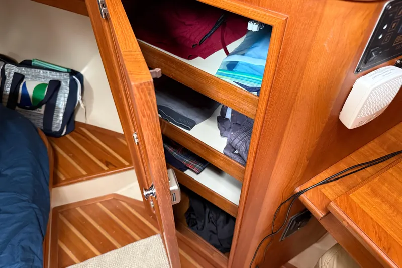 Pelican Yacht Photos Pics Interior of 2008 Island Packet 370 sailboat with wooden cabinetry and storage shelves.