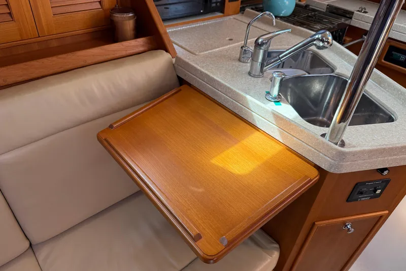 Pelican Yacht Photos Pics Interior of 2008 Island Packet 370 yacht with wooden table and kitchen sink.
