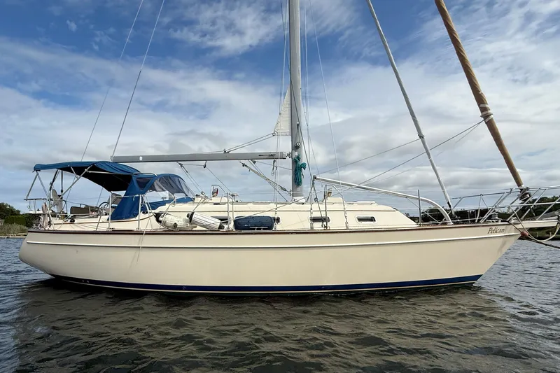 Pelican Yacht Photos Pics 2008 Island Packet 370 sailboat on water under cloudy sky.