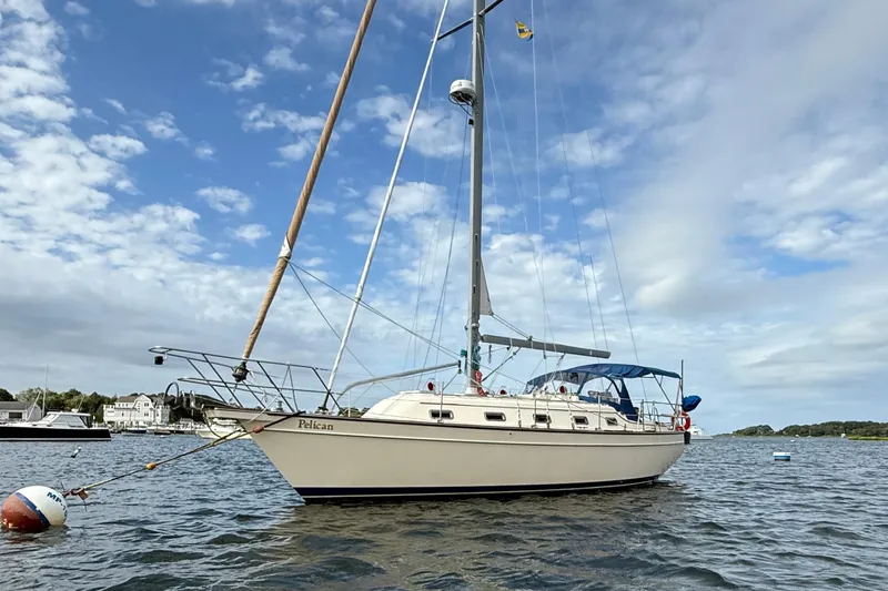 Pelican Yacht Photos Pics 2008 Island Packet 370 sailboat anchored on a calm, scenic waterway.