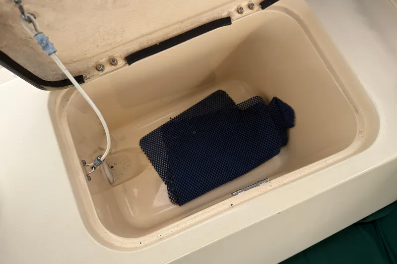 Pelican Yacht Photos Pics Open storage compartment on 2008 Island Packet 370 sailboat with blue mat inside.