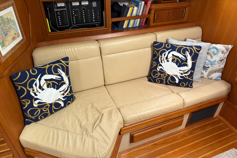 Pelican Yacht Photos Pics Interior of 2008 Island Packet 370 with beige sofa and decorative crab pillows.