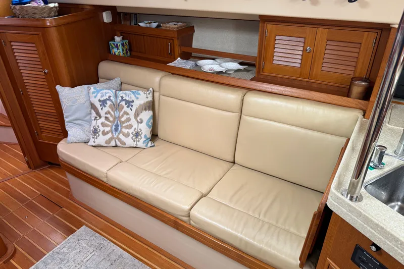 Pelican Yacht Photos Pics Interior of 2008 Island Packet 370 yacht with beige leather seating and decorative pillows.