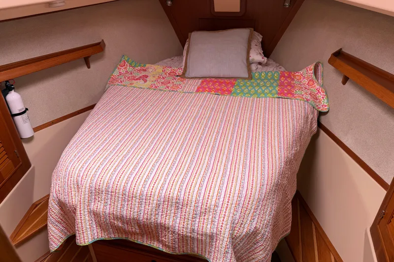 Pelican Yacht Photos Pics Cozy cabin interior of 2008 Island Packet 370 sailboat with colorful bedding.