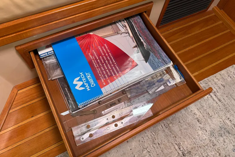 Pelican Yacht Photos Pics Open drawer with nautical charts and navigation tools on Island Packet 370, 2008 model.