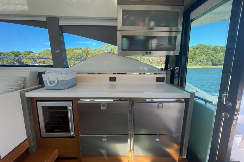Bar Dog Yacht Photos Pics Modern kitchen area on a 2020 Tiara 53C yacht with stainless steel appliances.