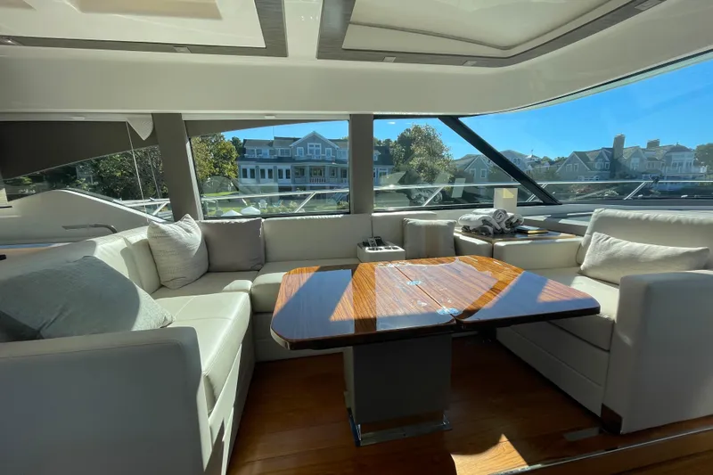 Bar Dog Yacht Photos Pics Luxurious interior of a 2020 Tiara 53C yacht with elegant seating and wooden table.