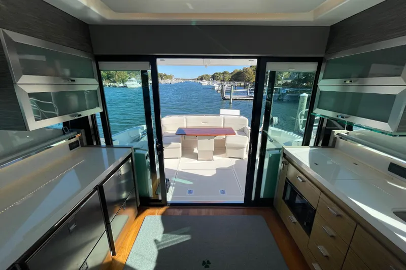 Bar Dog Yacht Photos Pics Luxurious 2020 Tiara 53C yacht interior with modern kitchen and scenic water view.