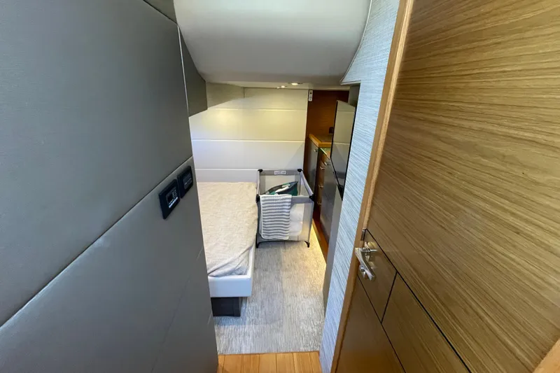 Bar Dog Yacht Photos Pics Interior of 2020 Tiara 53C yacht, featuring a cozy bedroom with modern design.