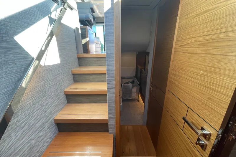 Bar Dog Yacht Photos Pics Interior view of 2020 Tiara 53C yacht with wooden stairs and modern design.