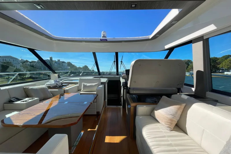 Bar Dog Yacht Photos Pics Luxurious interior of a 2020 Tiara 53C yacht with elegant seating and panoramic windows.