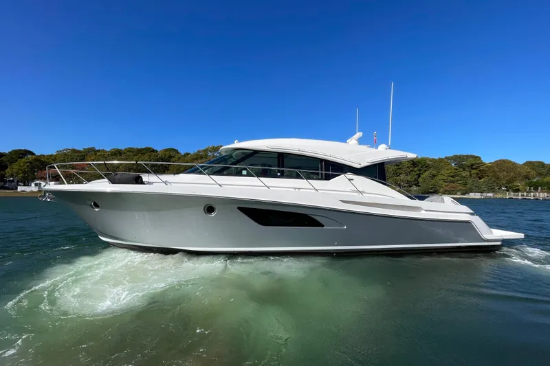 Bar Dog Yacht Photos Pics 2020 Tiara 53C yacht cruising on clear blue water under a bright sky.