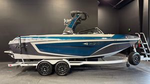 2022 Tigé 23ZX boat on trailer, blue and white design, displayed indoors.