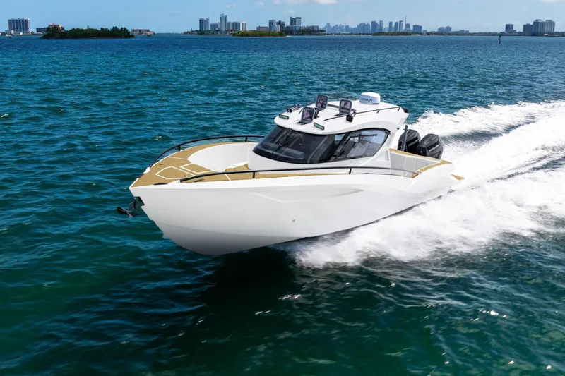  Yacht Photos Pics 2025 Novielli SERE luxury yacht cruising on blue ocean waters near city skyline.