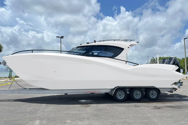  Yacht Photos Pics 2025 Novielli SERE boat on trailer under cloudy sky.
