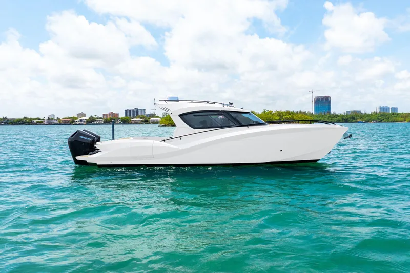  Yacht Photos Pics 2025 Novielli SERE boat on turquoise water under a cloudy sky.