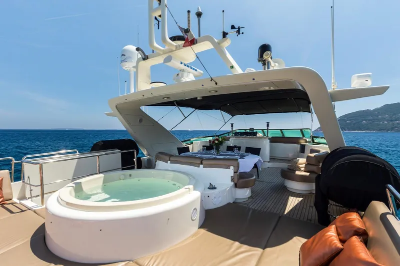  Yacht Photos Pics Luxurious 1999 Azimut 100 Jumbo yacht with jacuzzi and seating area on deck.