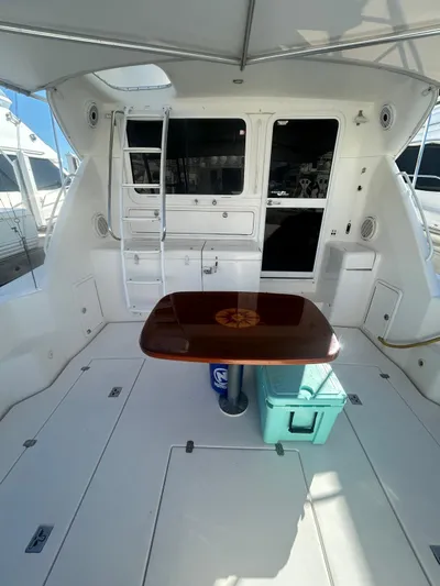  Yacht Photos Pics 2004 Riviera 40 yacht interior with table, ladder, and storage compartments.