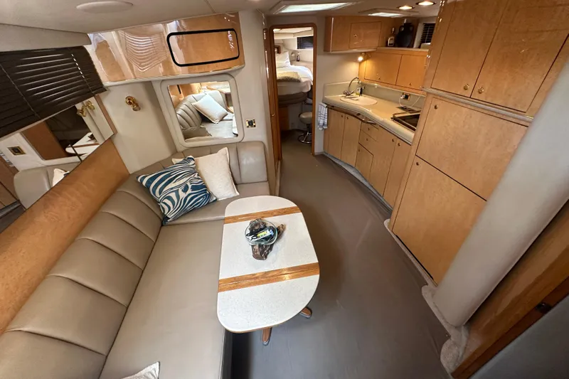 Bad Habit Yacht Photos Pics Luxurious interior of 1998 Sea Ray 450 Sundancer yacht with kitchen and seating area.