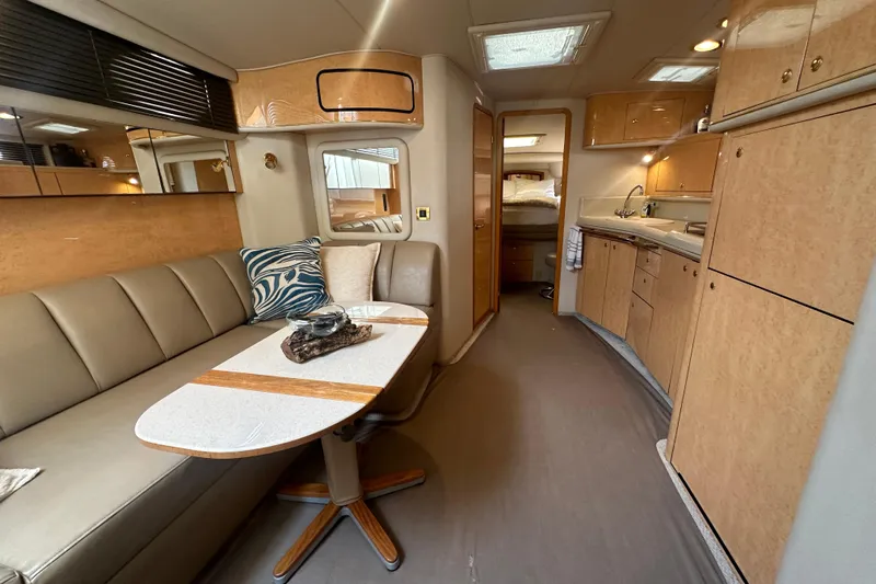 Bad Habit Yacht Photos Pics Luxurious interior of 1998 Sea Ray 450 Sundancer yacht with modern kitchen and seating area.