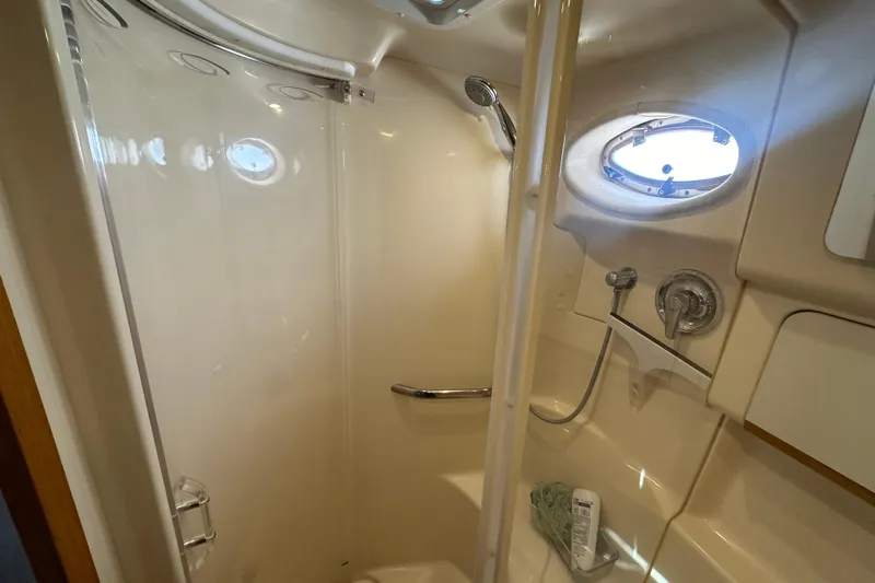 Bad Habit Yacht Photos Pics Shower area in 1998 Sea Ray 450 Sundancer yacht with porthole and fixtures.