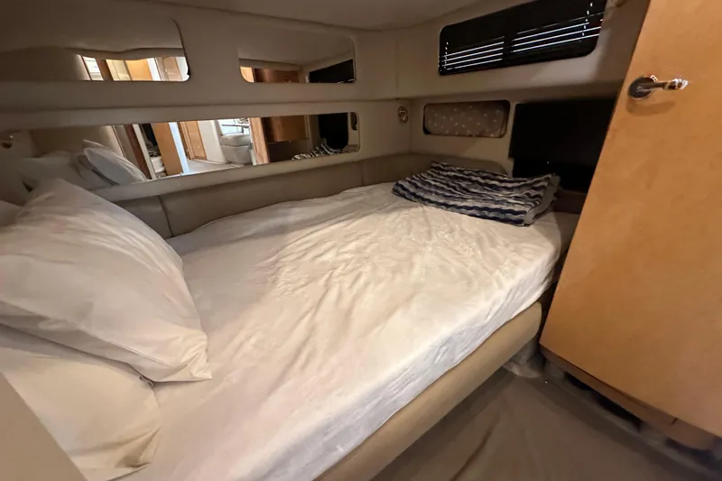 Bad Habit Yacht Photos Pics Cozy cabin interior of 1998 Sea Ray 450 Sundancer with bed and pillows.
