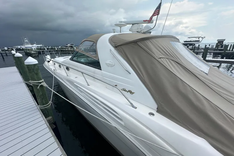 Bad Habit Yacht Photos Pics 1998 Sea Ray 450 Sundancer yacht docked, featuring sleek design and covered deck.