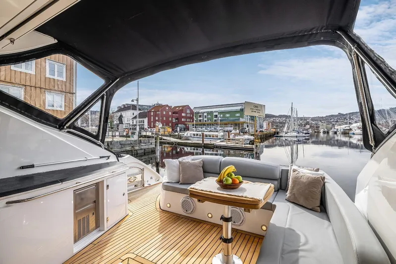  Yacht Photos Pics Luxurious 2008 Sunseeker Predator 62 yacht interior with marina view, featuring elegant seating and table.