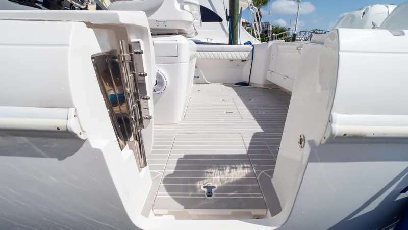  Yacht Photos Pics 2022 Intrepid 345 Valor boat deck with open side door, showcasing spacious interior.