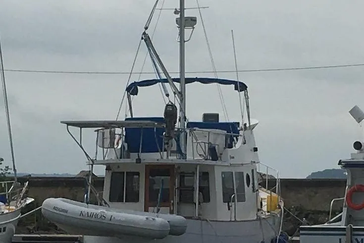  Yacht Photos Pics 1997 Willard Marine 40 Pilothouse Trawler docked with inflatable boat attached.
