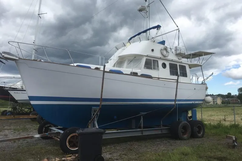  Yacht Photos Pics 1997 Willard Marine 40 Pilothouse Trawler on trailer, under cloudy sky.