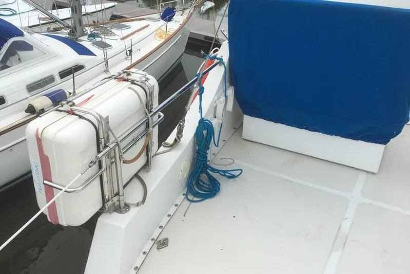  Yacht Photos Pics 1997 Willard Marine 40 Pilothouse Trawler deck with lifebuoy and blue cover.