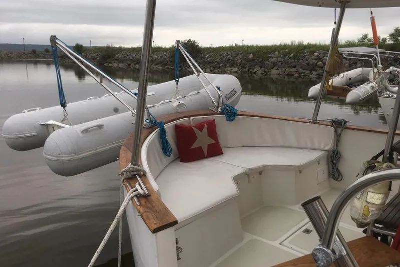  Yacht Photos Pics 1997 Willard Marine 40 Pilothouse Trawler with dinghy, docked in calm waters.