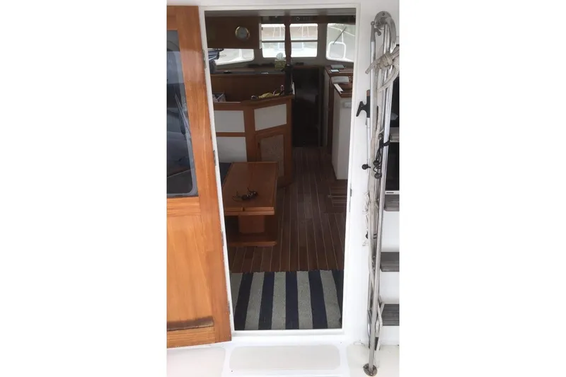  Yacht Photos Pics Interior view of 1997 Willard Marine 40 Pilothouse Trawler with wooden flooring and nautical decor.