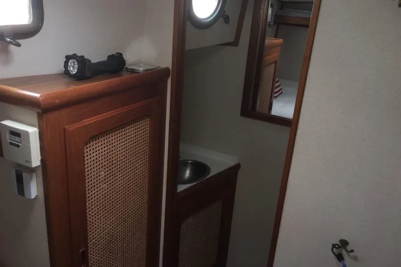  Yacht Photos Pics Interior of 1997 Willard Marine 40 Pilothouse Trawler with wooden cabinetry and sink.