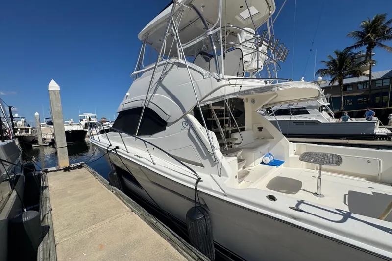  Yacht Photos Pics 2016 Riviera 43 Open Flybridge yacht docked at marina under clear blue sky.