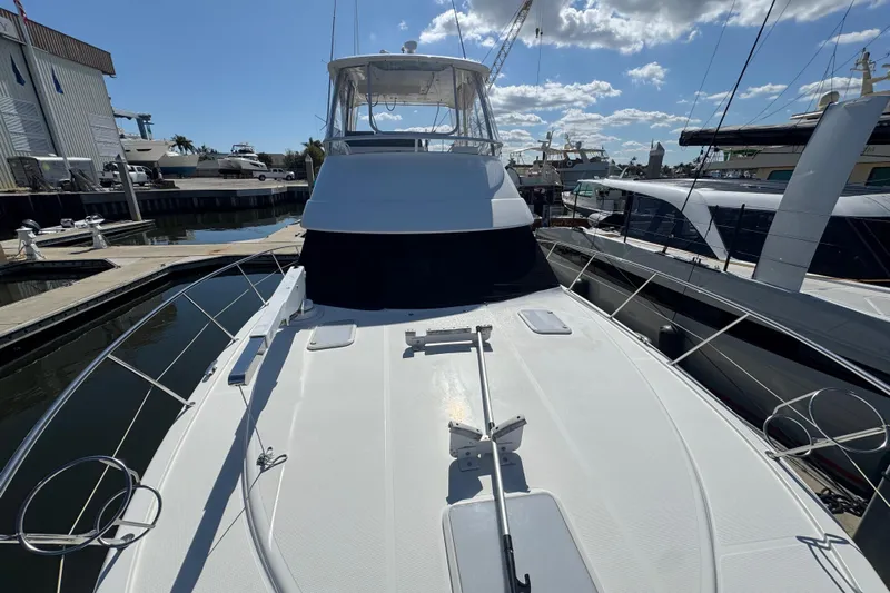 Yacht Photos Pics 2016 Riviera 43 Open Flybridge yacht docked at marina under blue sky.