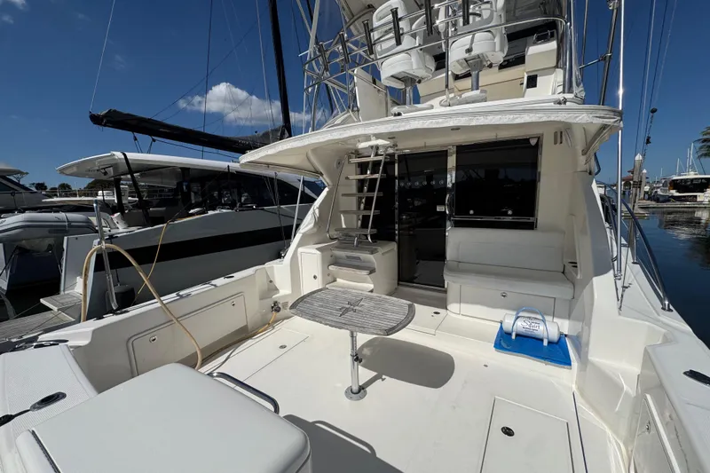  Yacht Photos Pics 2016 Riviera 43 Open Flybridge yacht with spacious deck and seating at marina.